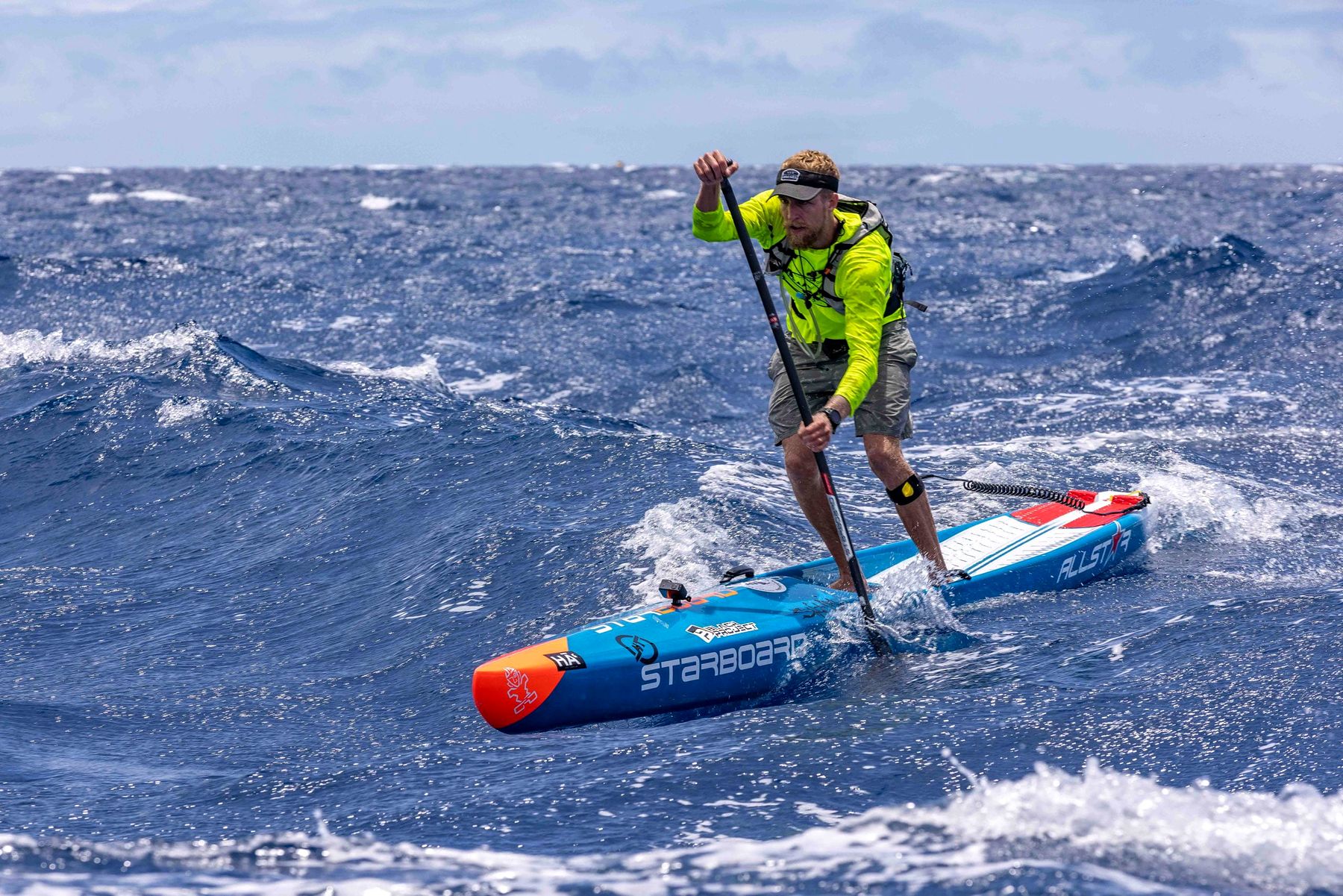 A stand-up paddler crosses the open channel