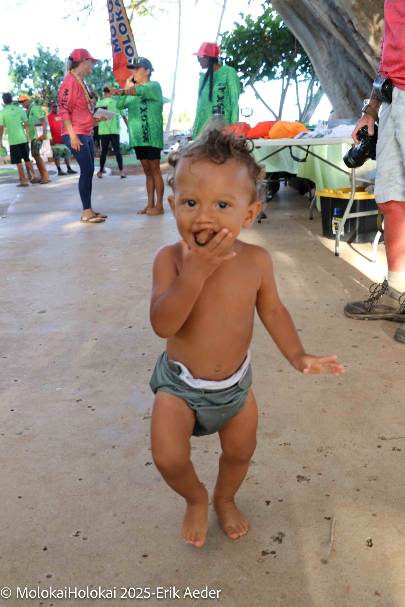 A toddler dances at the festival grounds